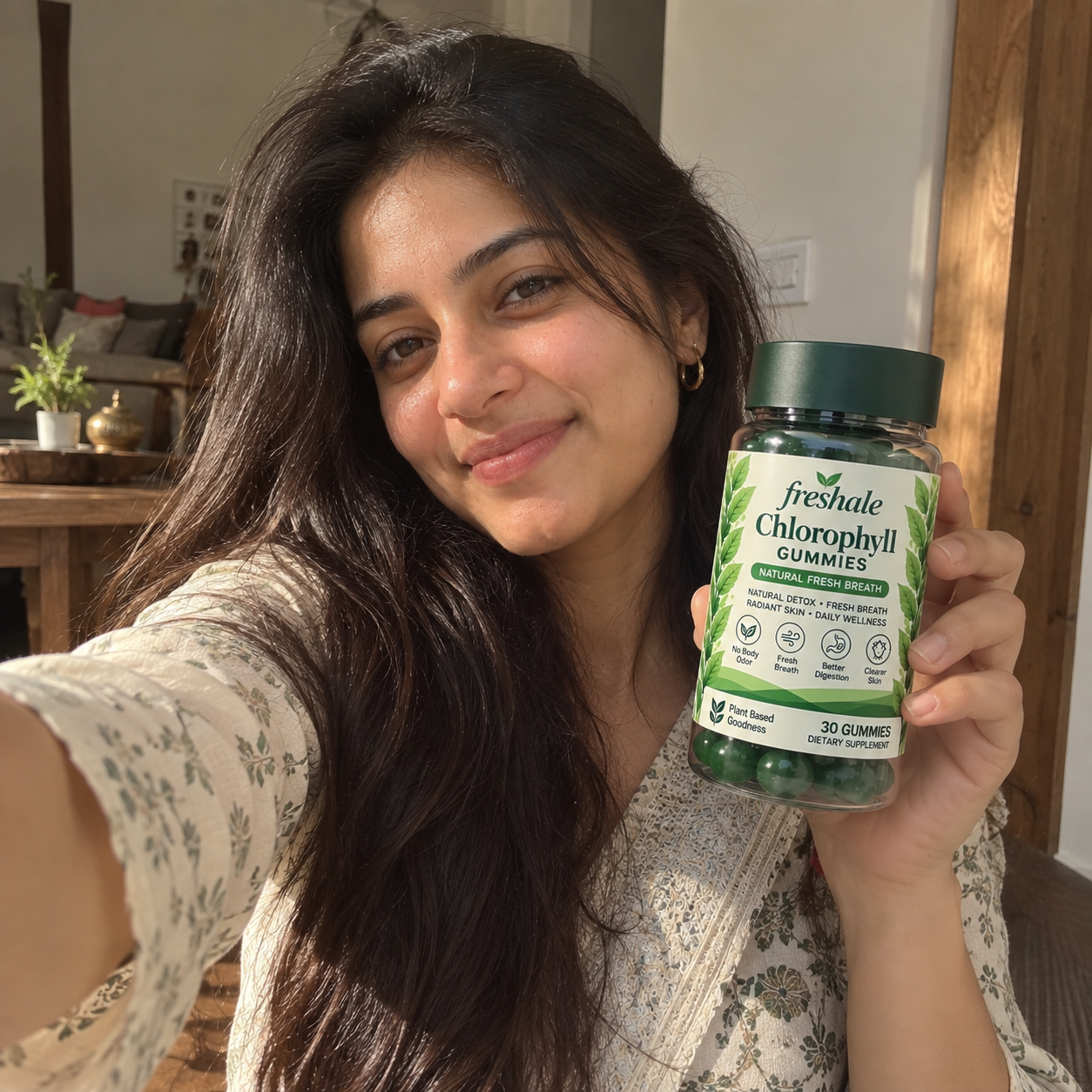 Woman smiling while holding a jar of Freshale Chlorophyll Gummies
